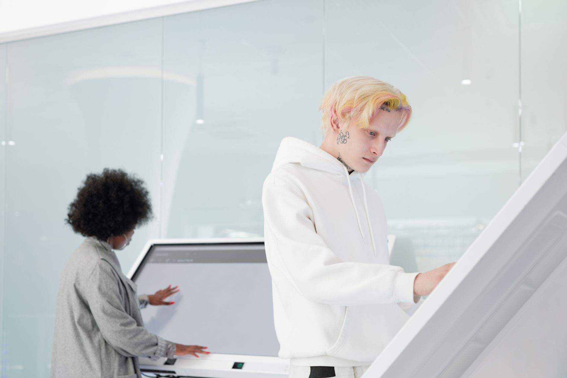 A diverse group of individuals of different ages and ethnicities interacting positively with advanced, yet user-friendly, health technology interfaces.