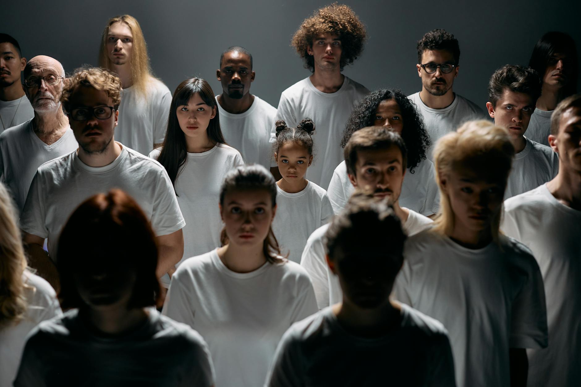 A diverse group of people of different ages and ethnicities, looking healthy and happy, with a subtle digital aura around them, representing the global impact of personalized health.